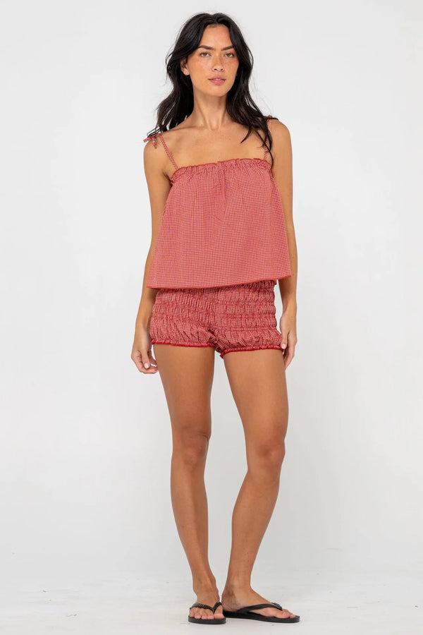 Model wearing red gingham cami top with adjustable tie straps