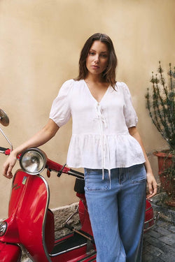 Effortless elegance in ivory – the Restore Linen Tie Front Peplum Top by Stories Be Told.