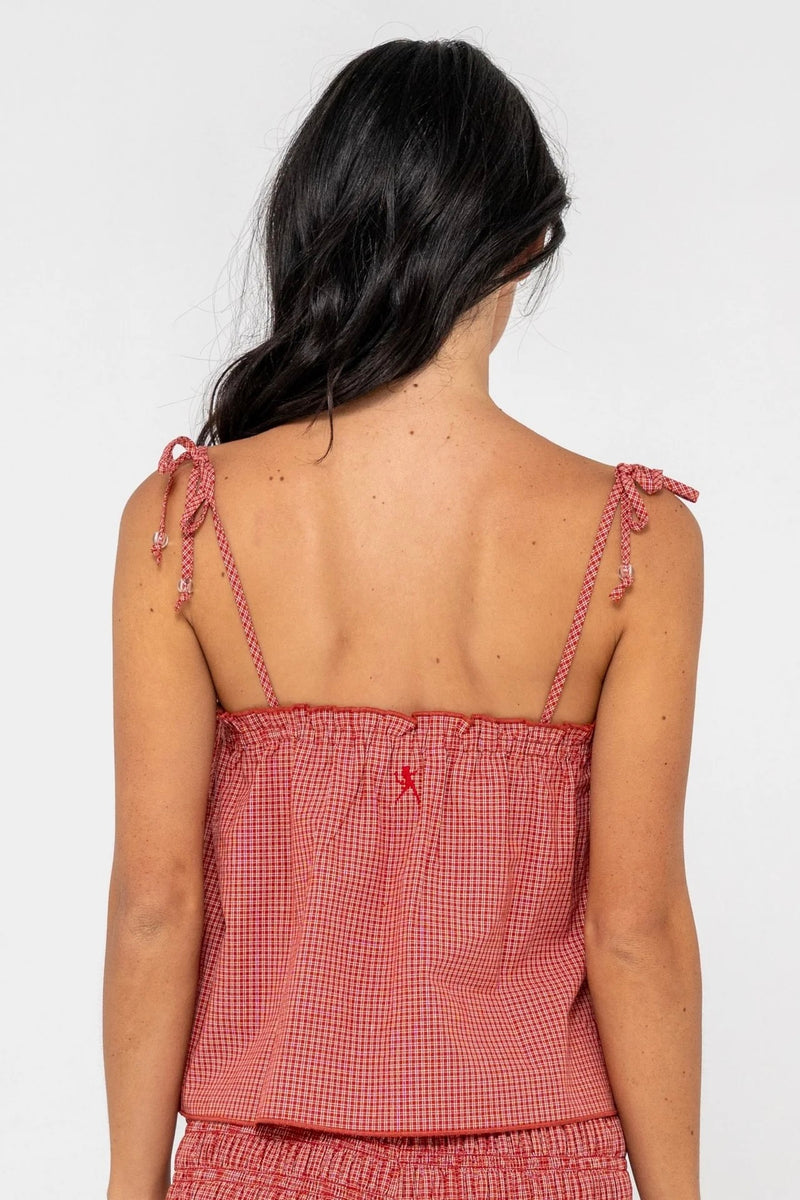 Model wearing red gingham cami top with adjustable tie straps