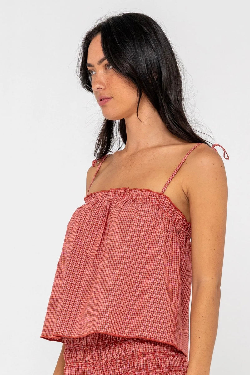 Model wearing red gingham cami top with adjustable tie straps
