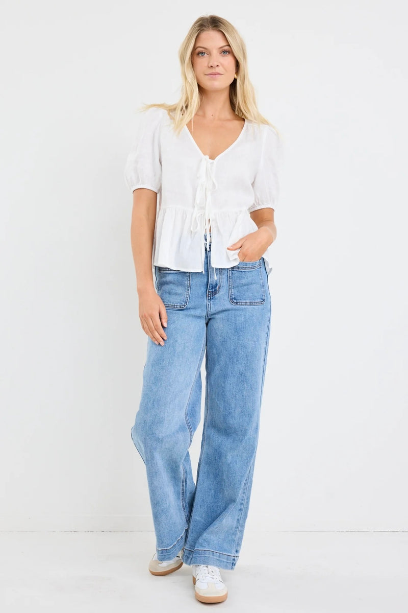 Effortless elegance in ivory – the Restore Linen Tie Front Peplum Top by Stories Be Told.