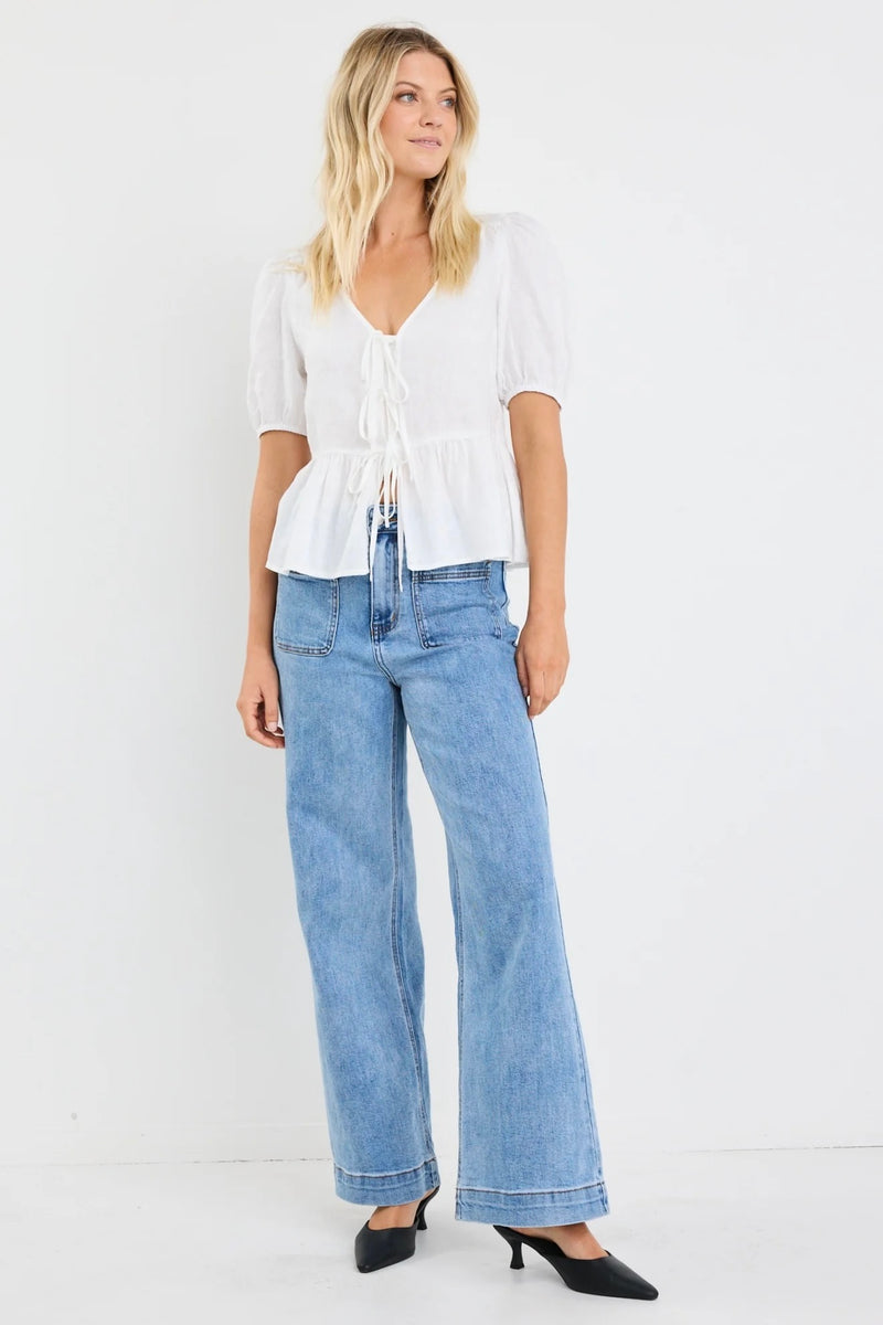 Effortless elegance in ivory – the Restore Linen Tie Front Peplum Top by Stories Be Told.