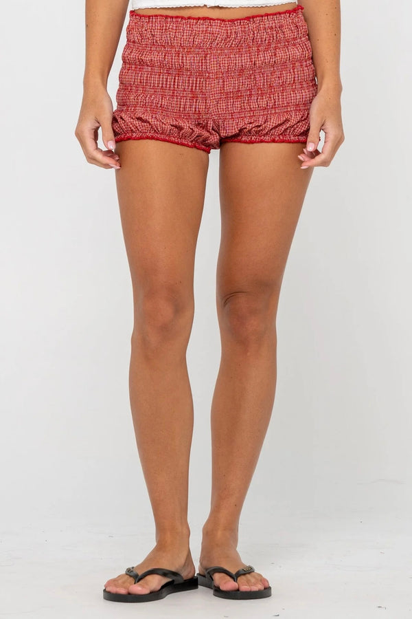 Model wearing red gingham shirred bloomer shorts