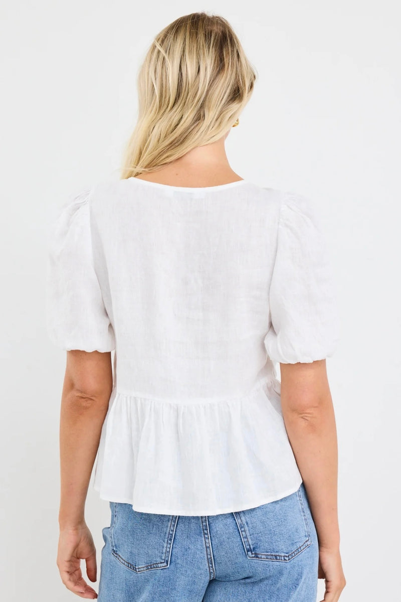 Effortless elegance in ivory – the Restore Linen Tie Front Peplum Top by Stories Be Told.
