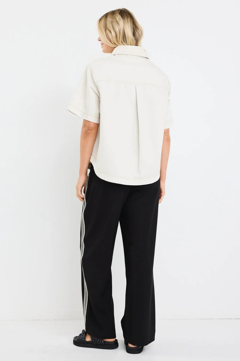 Model wearing ecru short sleeve denim shacket with chest pockets