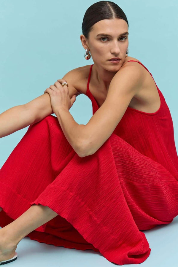 Model wearing Staple The Label Amira Dress in red, maxi length with spaghetti straps
