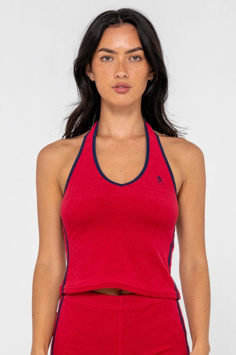 Model wearing red towelling halter neck top with contrast trim