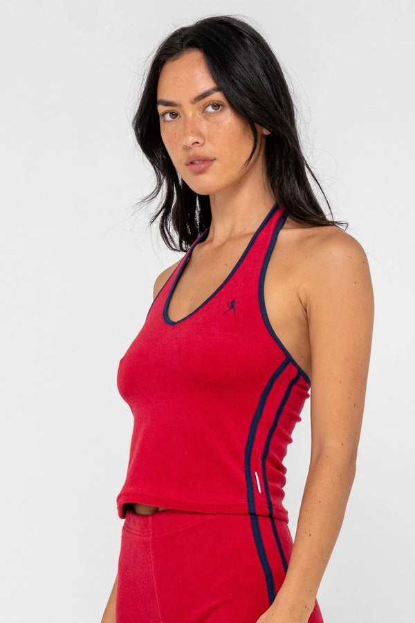 Model wearing red towelling halter neck top with contrast trim
